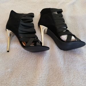 Never worn, dressy, strappy, high heels.